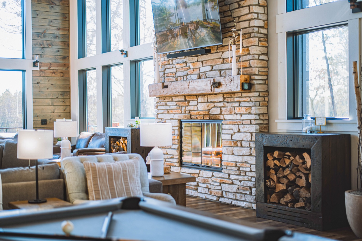 The stone fireplace glowing at dusk